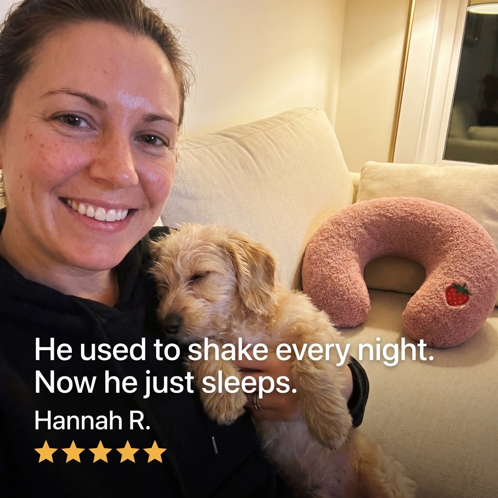 Hannah holding her small dog beside a pink PawCalm pillow, five-star review: he sleeps through the night now
